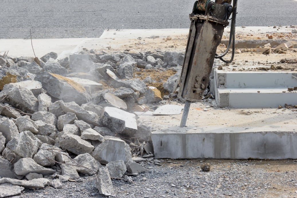 Breaking concrete with machine drilling or pneumatic hammer